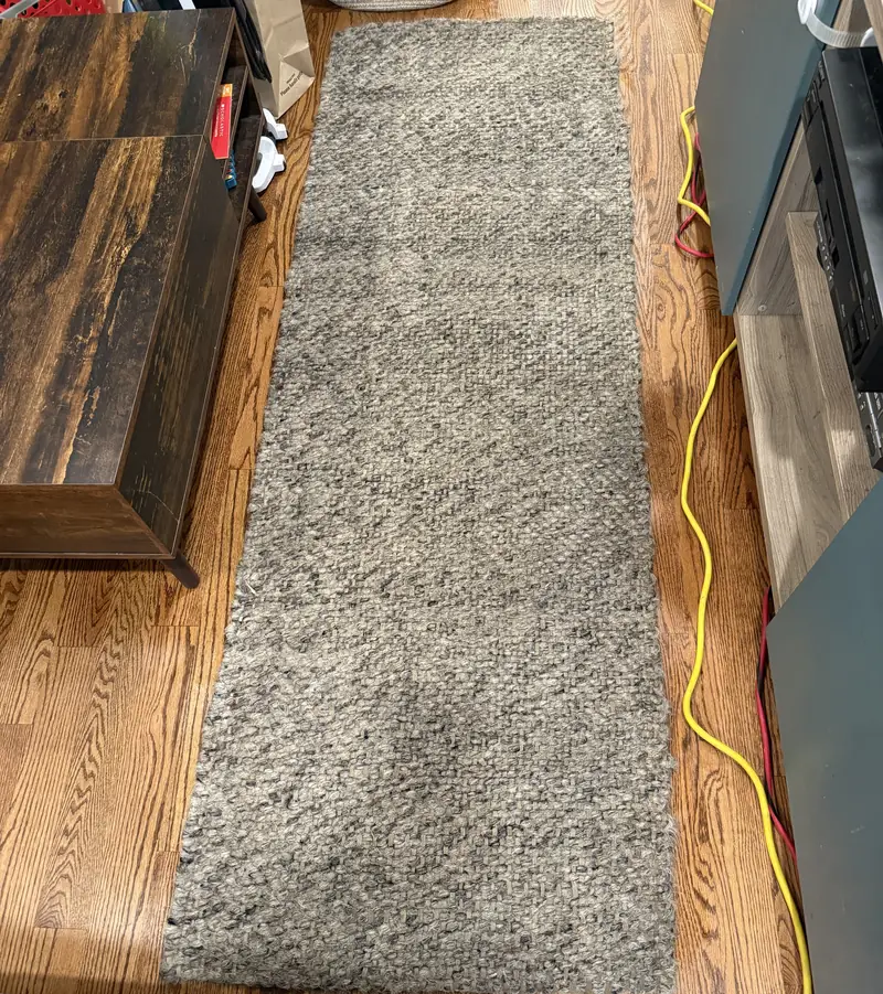 Gray textured runner rug on a hardwood floor after on-site cleaning in Chicago
